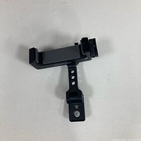 Side view of Arnarkok metal phone clamp showing adjustable arm and mounting plate