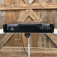 Front view of Behringer EP1500 amplifier on stand