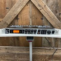 Front view showing model, display illuminated, controls and rack ears