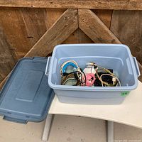 Overall view of blue tote with lid and mixed cables inside