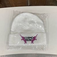Front view of sealed white toque showing logo embroidery