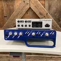 Front view of Digidesign MBox 2 and M-Audio Quattro showing controls and branding