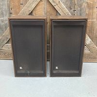 Front view with grills on showing both cabinets