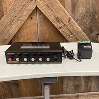 Front view of Hwameo HE-101 echo mixer with included power adapter visible