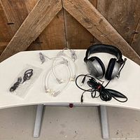 All items on table: Nexxtech headset, two clear tube headphones, packaged Electra earbuds