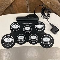 Front view showing seven pads and control panel