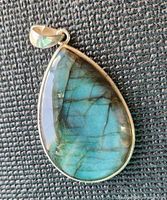 Front view of labradorite pendant showing blue/green flash and silver bezel