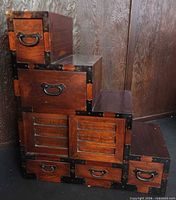 Front view showing drawers, sliding doors, iron brackets