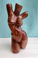 Front view of hardwood female torso sculpture showing overall form and finish