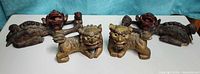 All four wooden guardian lions grouped