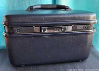 Front view of dark blue Samsonite hard cosmetic case showing combination lock