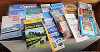 Full spread of travel guides and maps showing titles and condition