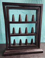 Front view showing entire wooden rack with 12 cones