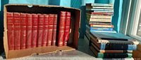 Front view of encyclopedia set in box and adjacent stack of assorted books