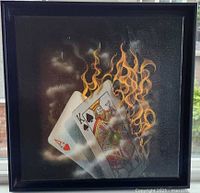 Front view of framed canvas showing burning playing cards artwork