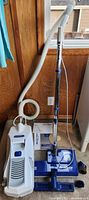 Full view of canister vacuum, hose, wand, powerhead, manual and bags