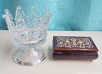 Music box and glass crown bowl side by side