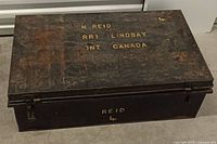 Closed chest showing stencilled lettering and rusted exterior