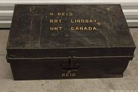 Closed metal chest with stencilled lettering