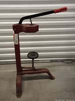 Side view of full corker showing frame, handle, and bottle platform