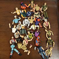 Overview of all loose G.I. Joe figure parts spread on surface
