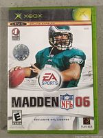 Front cover of Madden NFL 06 Xbox game in green case
