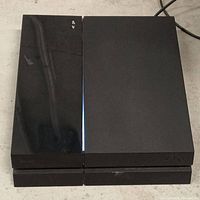 Top view of Sony PlayStation 4 console showing blue power light