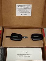 Box opened showing two Numeris PPM-360 meters with instruction sheet