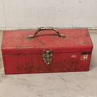Closed red toolbox front view with handle and latch