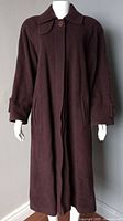 Front view of dark brown virgin wool women’s coat on mannequin