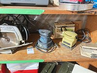 Shelf with three Black & Decker power tools