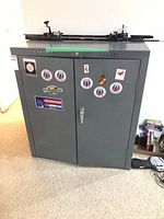 Front view of gray metal Caprice Classic cabinet with stickers