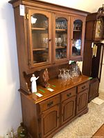 Full view of china cabinet showing upper glass doors and lower storage