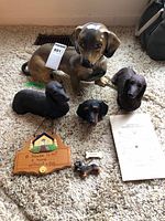 Group shot of all dachshund statues, figurines, sign, ornament and paper