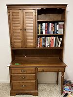 Front view showing entire desk and hutch, drawers, cabinet doors, shelving