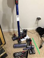 Vacuum wand and attachments on floor