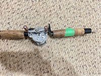 Reel mounted on cork-handle rod showing overall wear