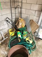 Overall view of assorted garden items in garage corner