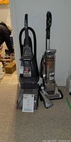 Both vacuum units side-by-side showing overall condition and included manual
