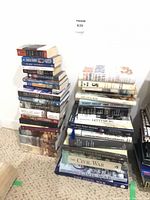 Two floor stacks of roughly 40 Civil War themed books, showing spines and partial covers