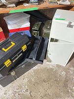 Group view showing toolbox, footlocker, tool tray, cabinet, clear tote and ammo cans