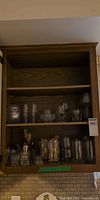 Cabinet view showing majority of glassware on two shelves