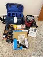Grouped shot showing cameras, lenses, flash, bags and accessories