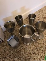 Six pewter vessels grouped: tankard, two goblets, two tall cups, Jefferson cup