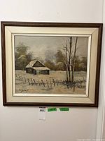 Framed winter landscape painting hanging on wall