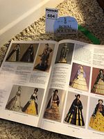 Book open displaying color plates of figurines