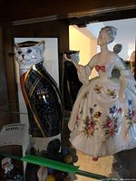 Front view of both figurines in display cabinet