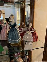 Shelf view showing Belle O'The Ball and Clarinda figurines