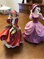 Both Royal Doulton figurines front view on table