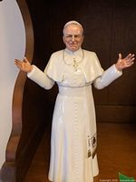 Full view of figurine front with arms outstretched